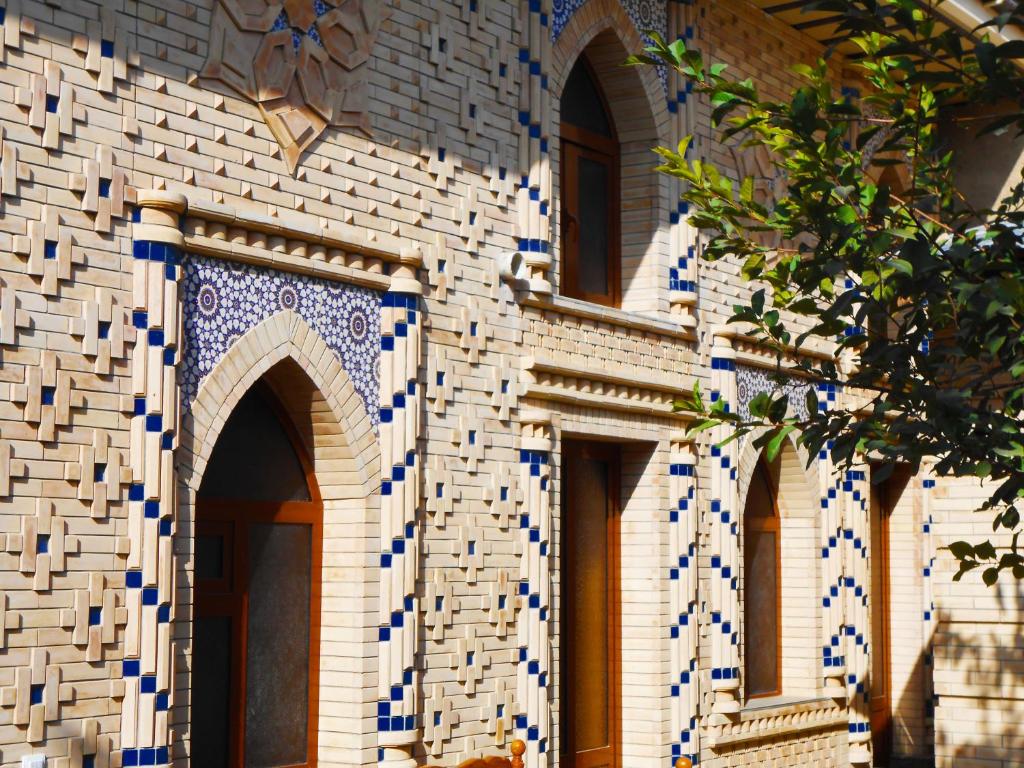 a building with blue and white tiles on it at Colibri Traditional Hostel in Samarkand