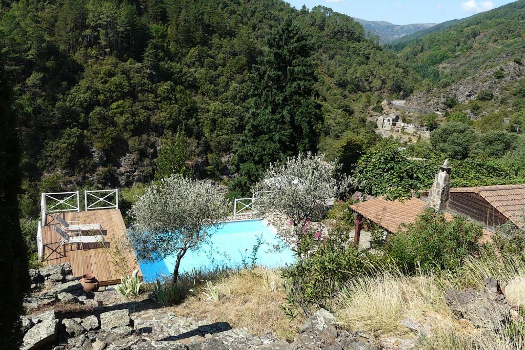 a swimming pool in the middle of a mountain at Studio La maison bleue in Saint-Mélany