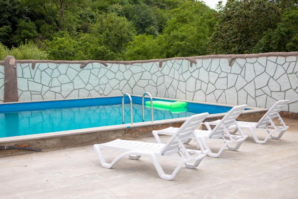 a group of chairs and a swimming pool at Spitak tun in Ijevan