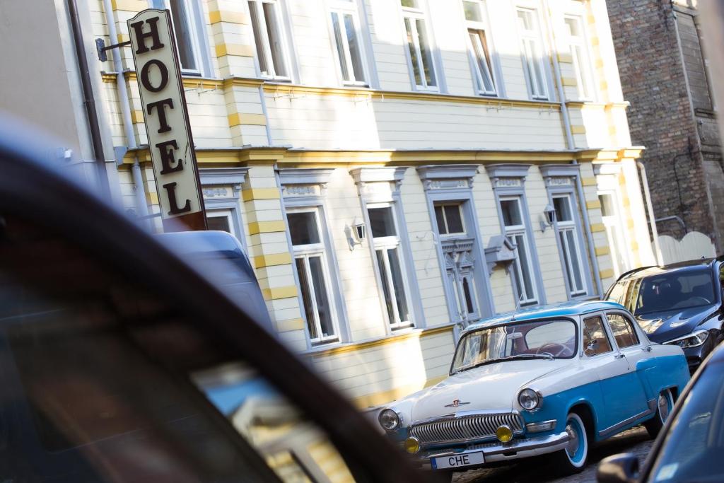 a car is parked in front of a building at MORE Hotel in Liepāja