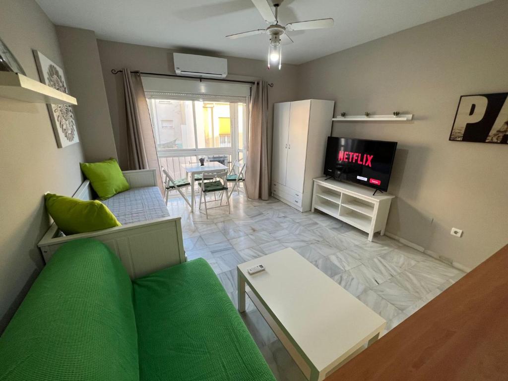 salon z kanapą i telewizorem w obiekcie Genuar Apartments Malaga Center 2 w Maladze