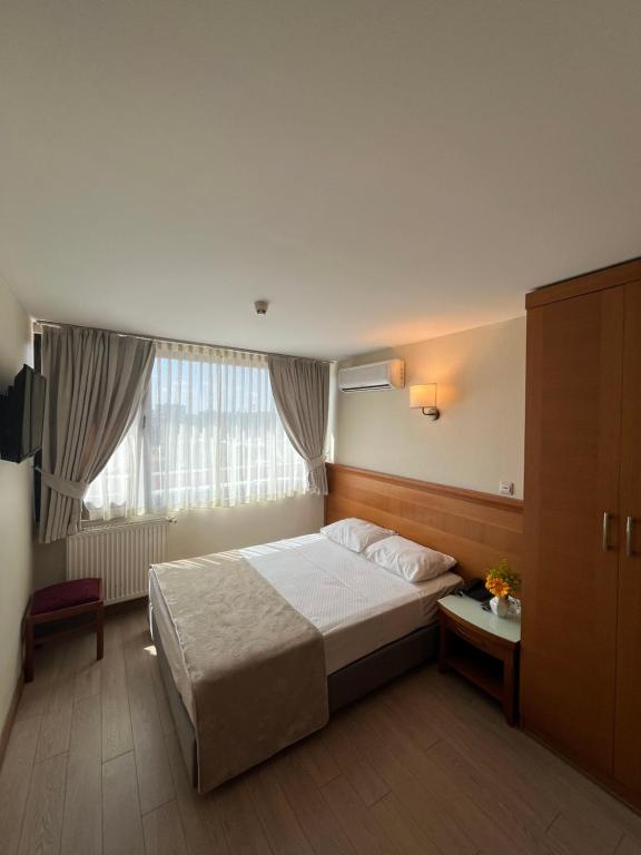 Un pat sau paturi într-o cameră la Yavuz Hotel