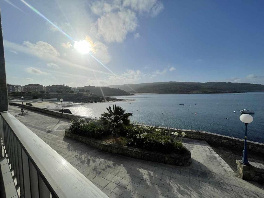 a balcony with a view of a body of water at Grupo Gontad Casa Baixo da Capilla Corme in A Coruña