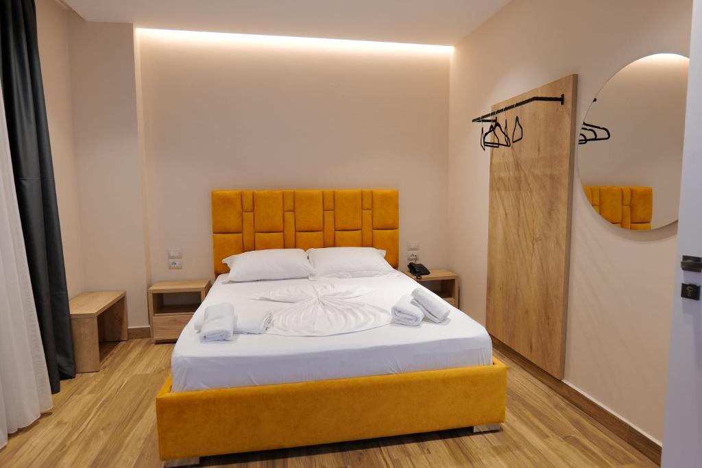 a bedroom with a large bed with white sheets at Hotel Alexander in Ksamil