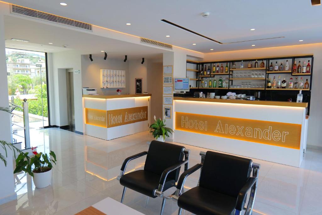 a hotel lobby with two chairs and a hotel adviser counter at Hotel Alexander in Ksamil