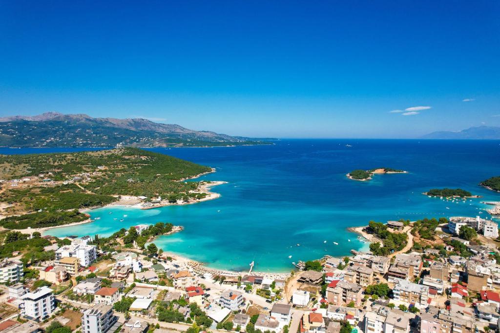 an aerial view of a city and the ocean at Hotel Alexander in Ksamil