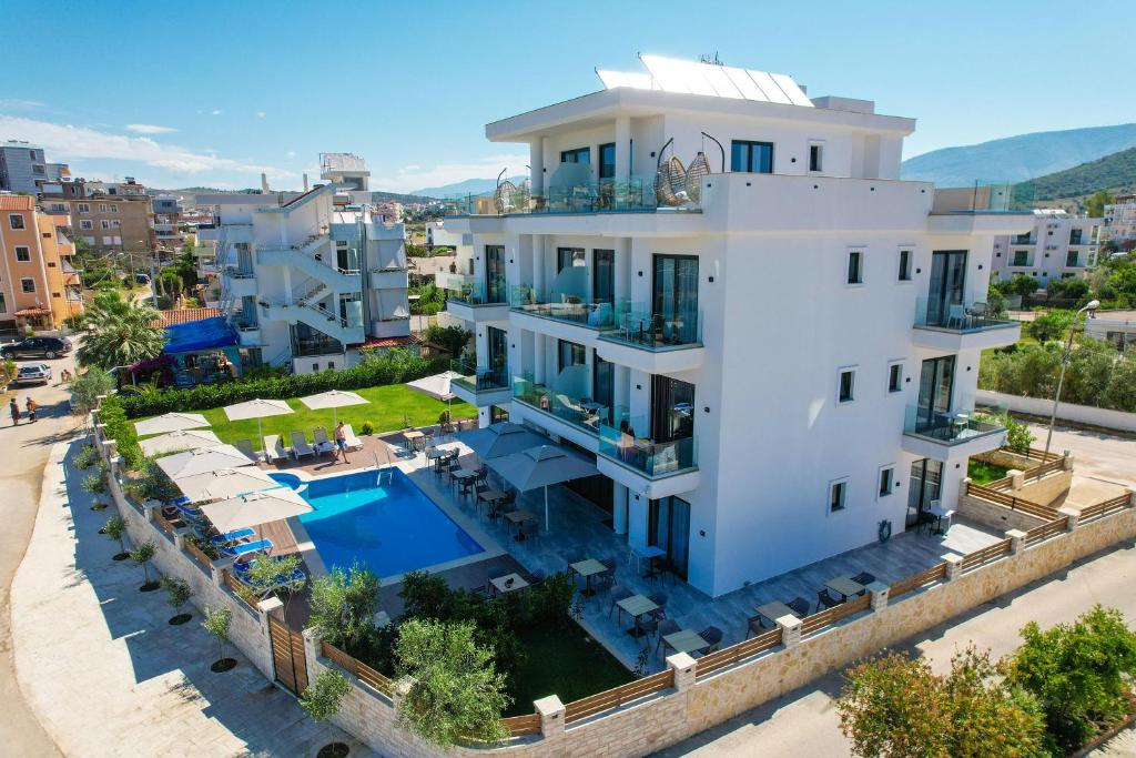 an aerial view of a white house with a swimming pool at Hotel Alexander in Ksamil
