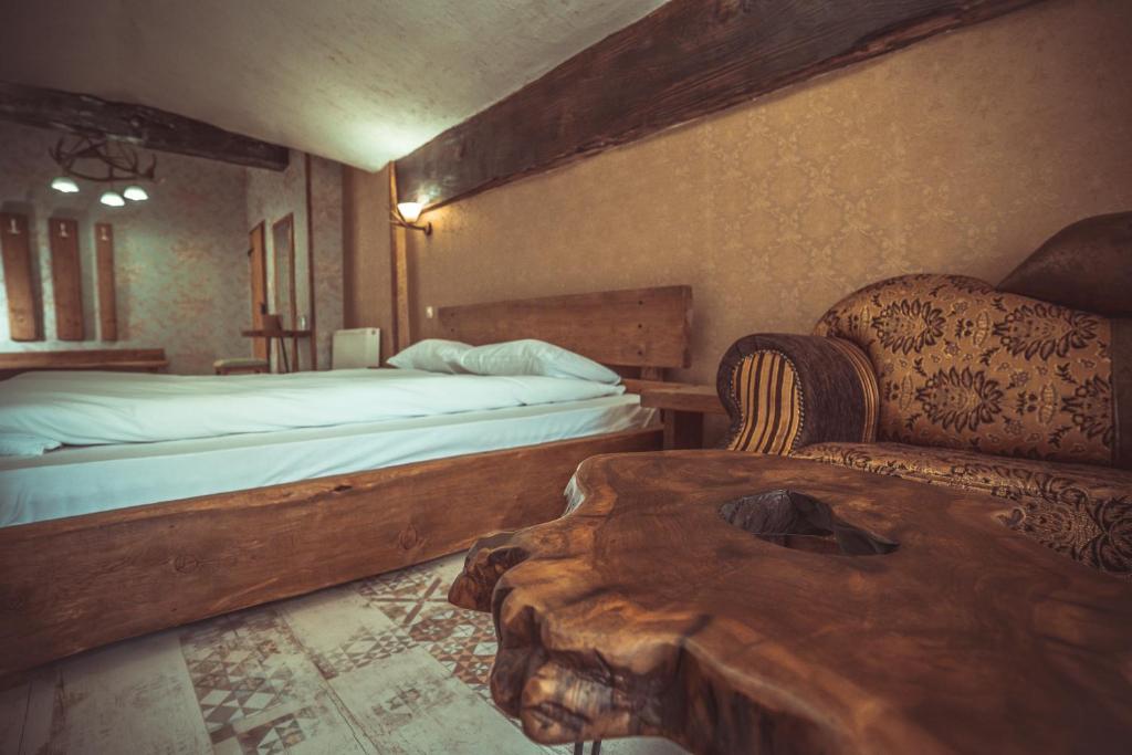 a bedroom with a bed and a couch and a table at Daulite boutique hotel in Rakovo