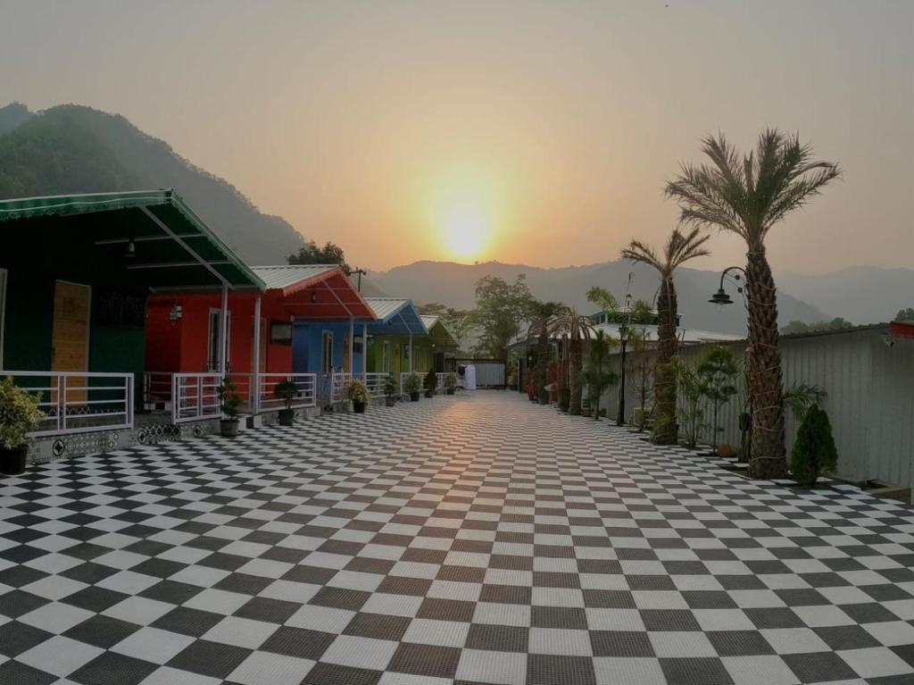 a street with a checkered floor and palm trees at MR River Resort in Rishīkesh