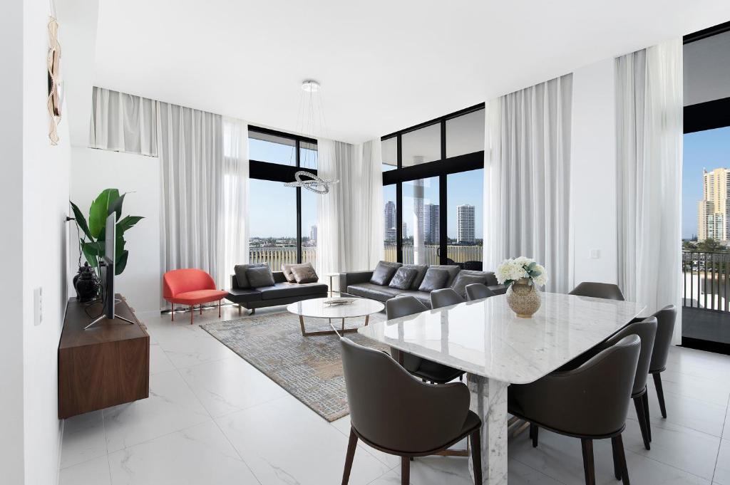 a living room with a table and a couch at LOTUS RESORT in Gold Coast