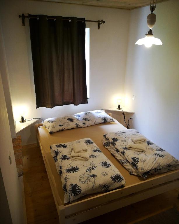 1 dormitorio con 2 camas y ventana en Apartma Caprivi Zavod za razvoj turizma Kočevski rog, en Kočevje
