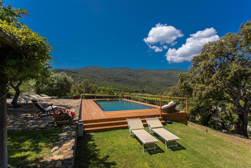 a swimming pool with lounge chairs next to at Country Relais La Mortella in Porto Ercole