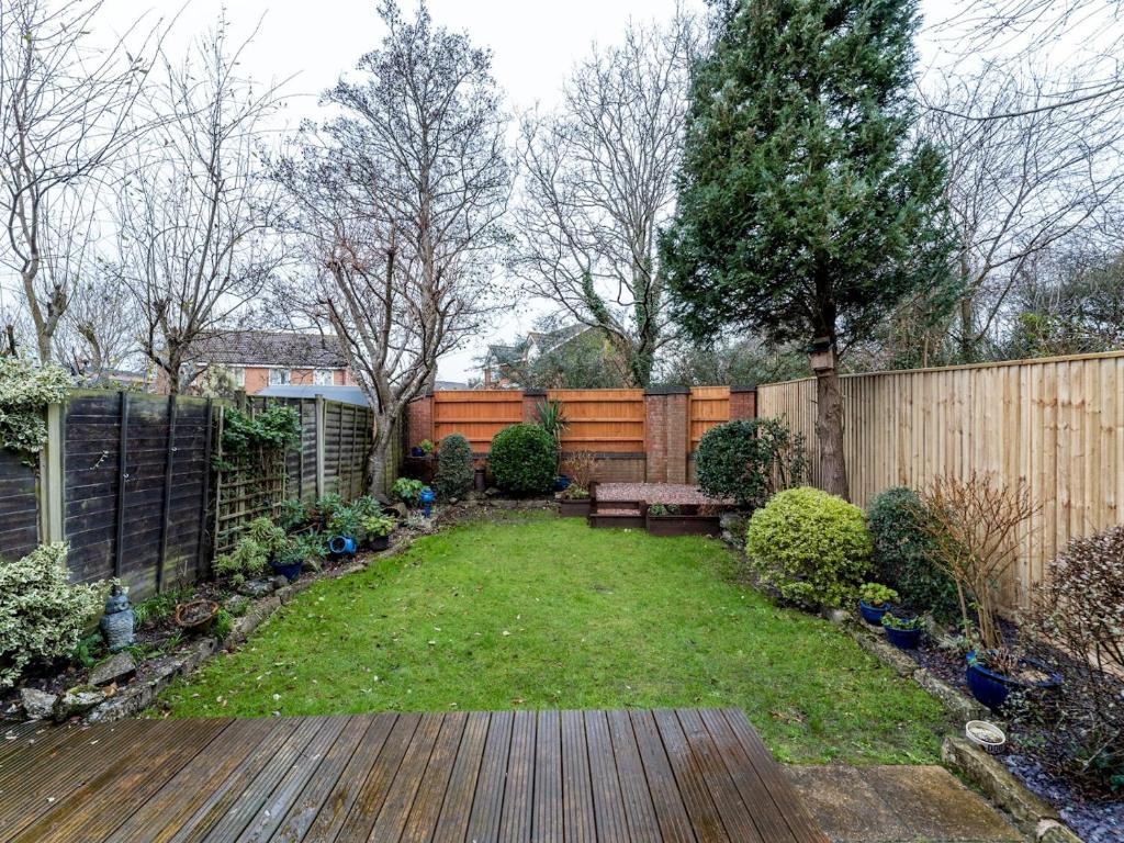 a backyard with a bench and a fence at Pass the Keys Private 2 Bedroom Gem with parking in Christchurch