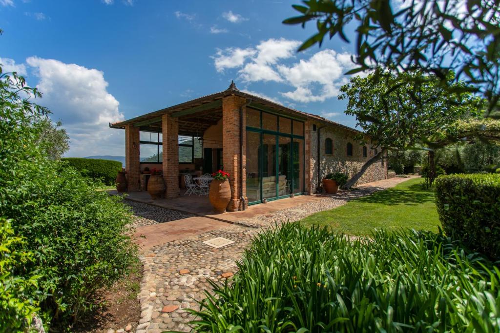 a house with glass doors on the front of it at Country Relais La Mortella in Porto Ercole