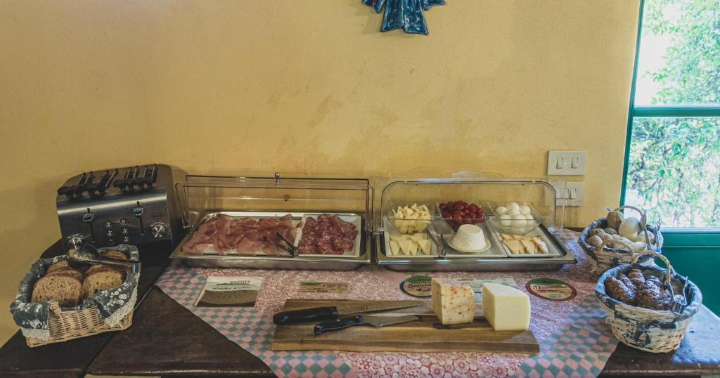 a table with some food on a table at Country Relais La Mortella in Porto Ercole