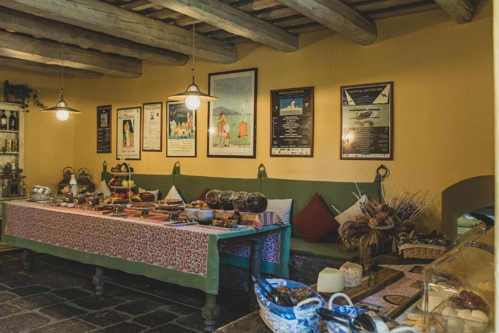 a dining room with a table and some pictures on the wall at Country Relais La Mortella in Porto Ercole