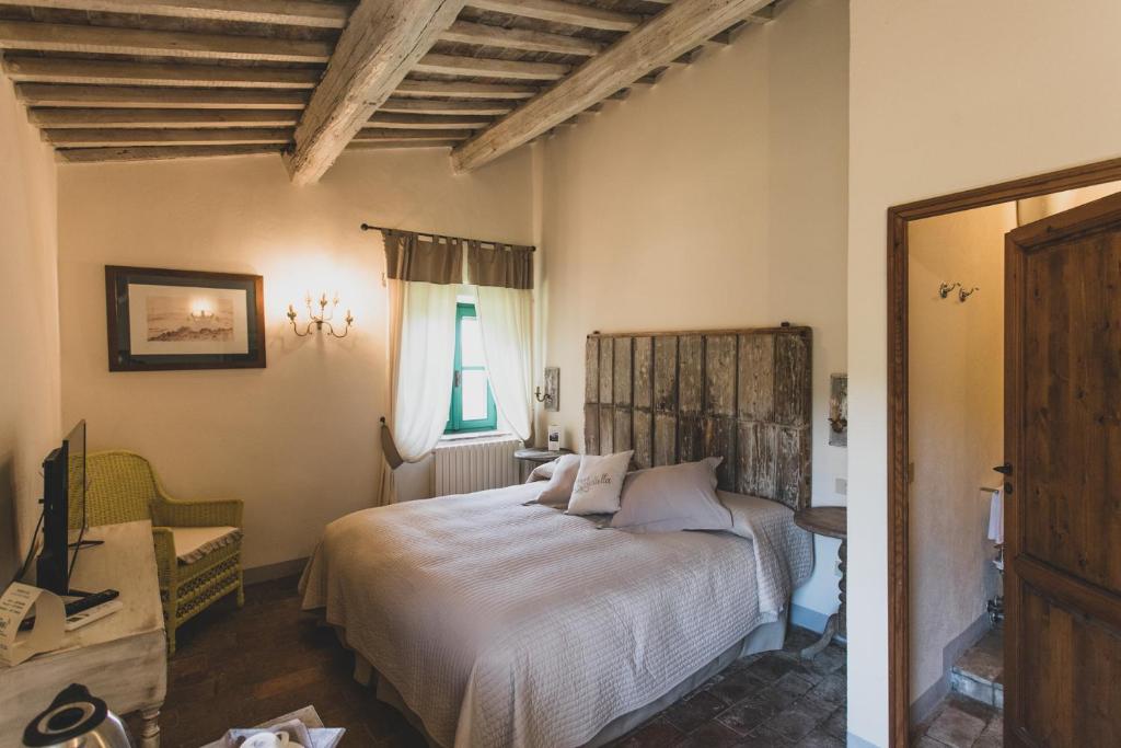 a bedroom with a bed in a room with a window at Country Relais La Mortella in Porto Ercole