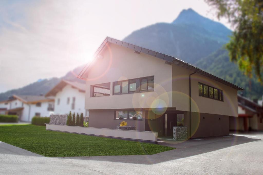 a house with a mountain in the background at Appartement Schöpf in Längenfeld