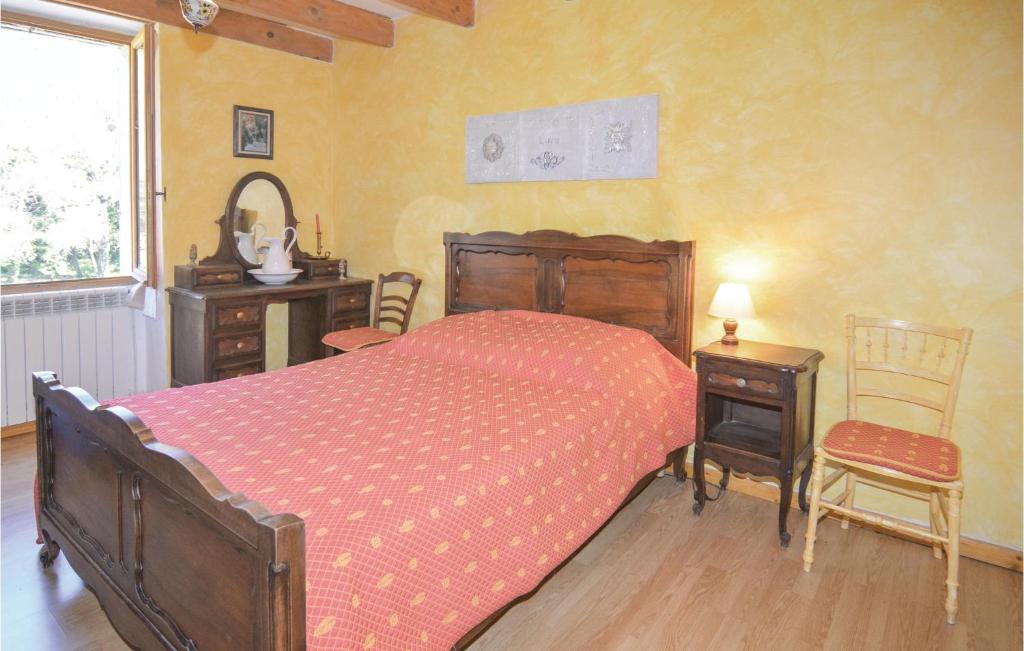 a bedroom with a bed and two tables and a window at Awesome Home In Bessges With Wifi in Bessèges
