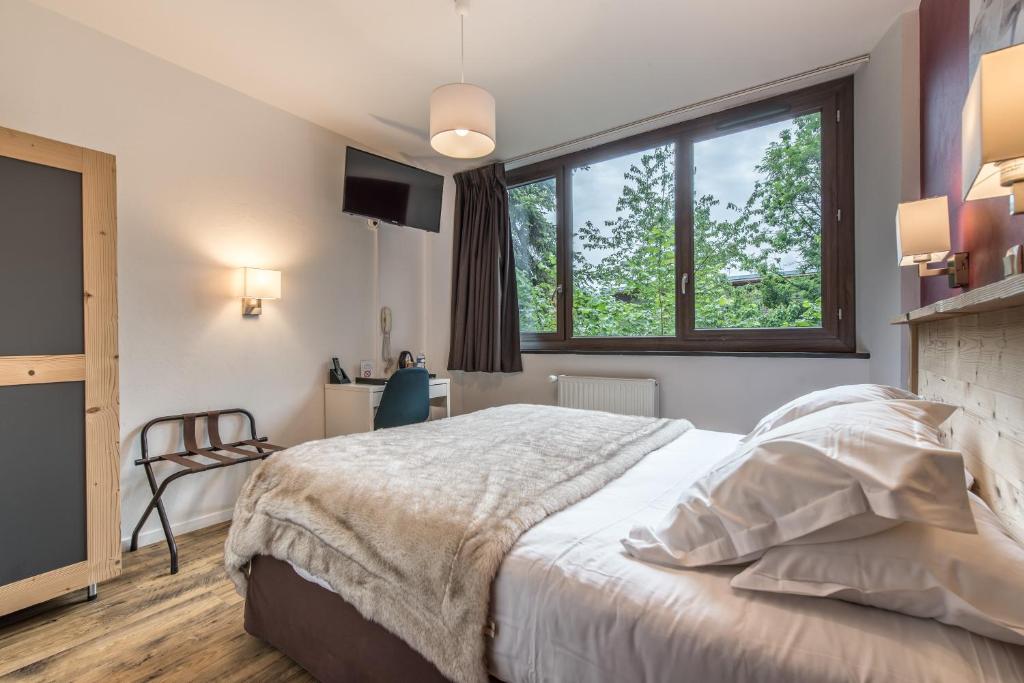 Postel nebo postele na pokoji v ubytování Hôtel Le Marintan