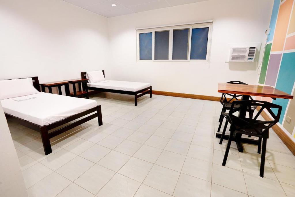 Postel nebo postele na pokoji v ubytování Nacho Hostel Cebu