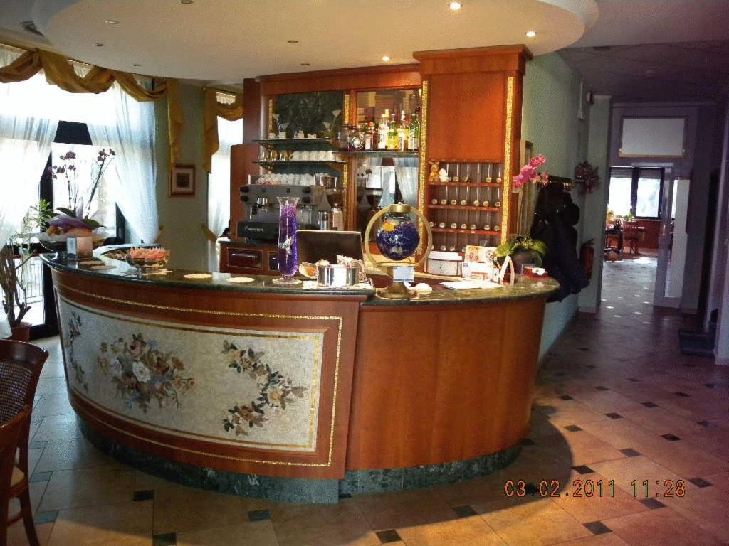a bar in a restaurant with a counter at Hotel Riviera in Marina di Ravenna
