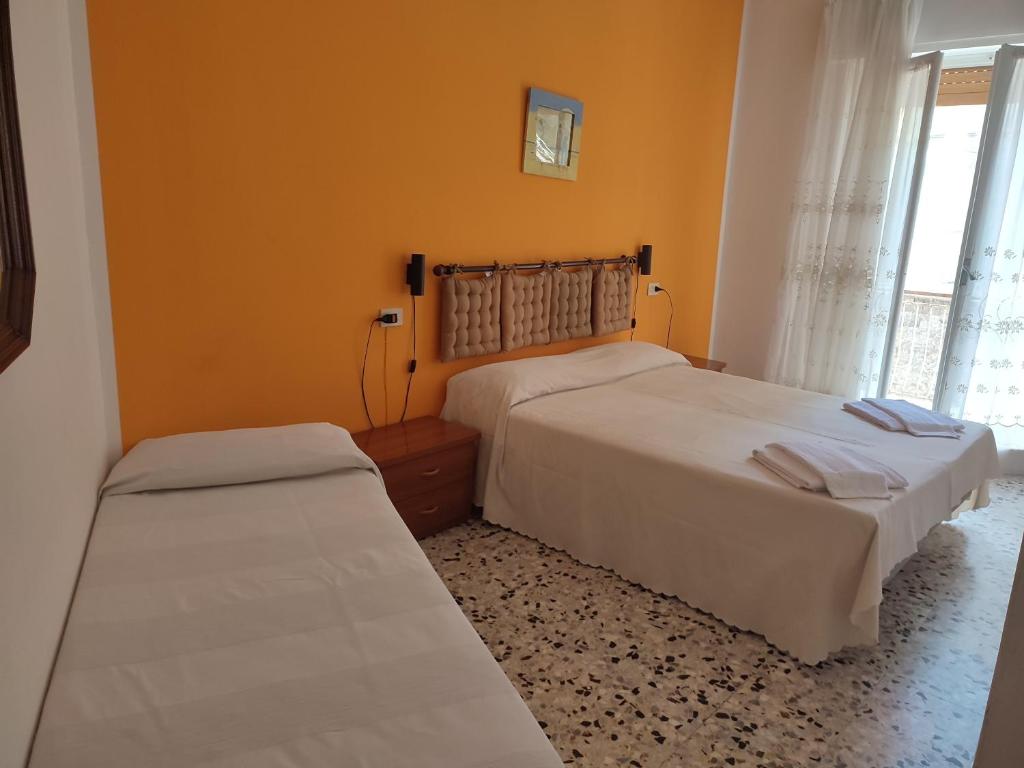 Postel nebo postele na pokoji v ubytování Albergo Nella