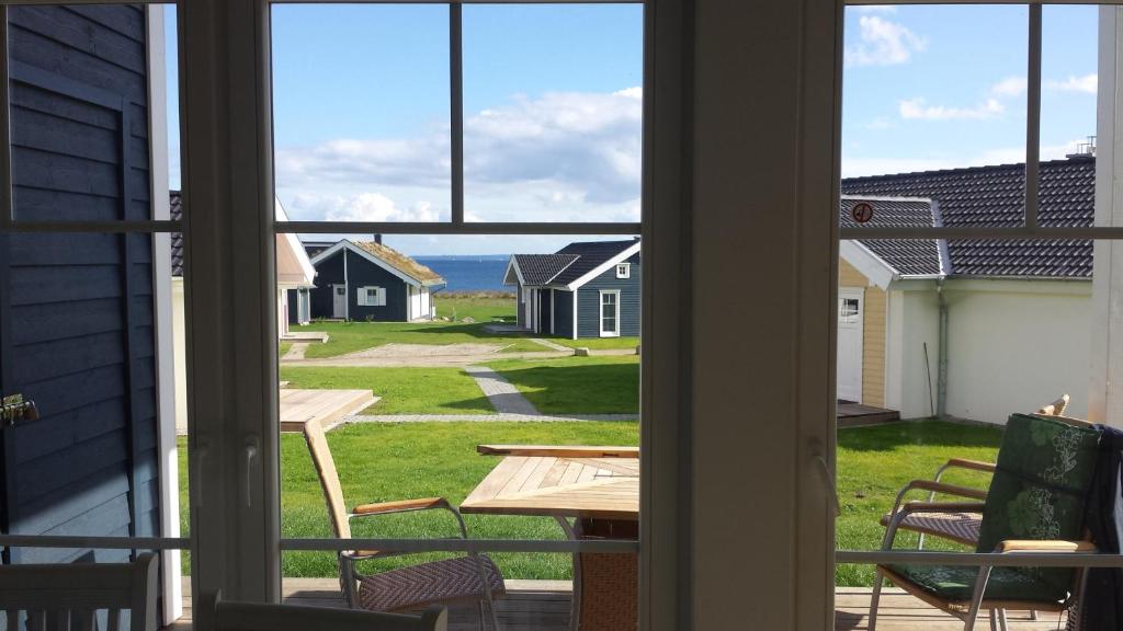 an open window with a view of the ocean from a house at Ferienhaus Heimathafen in Sierksdorf