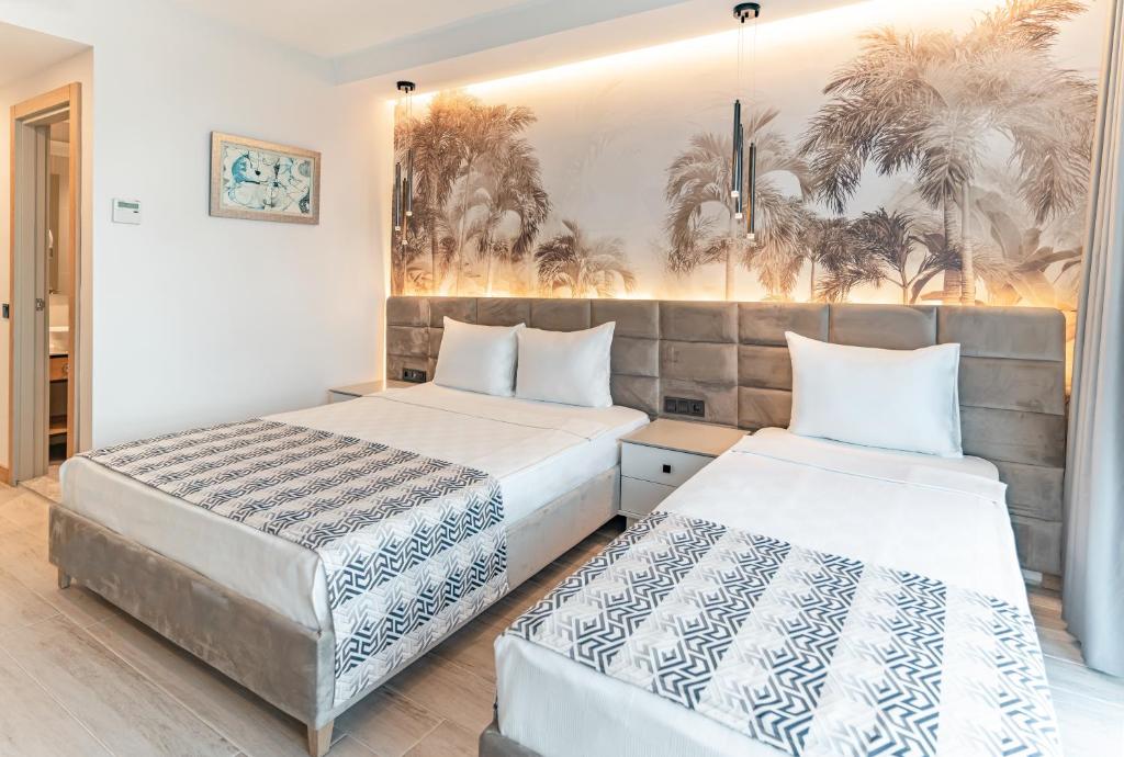 Postel nebo postele na pokoji v ubytování PEARLY HOTEL