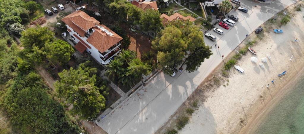 an overhead view of a beach with cars and trees at Villa Miranda in Nikiti