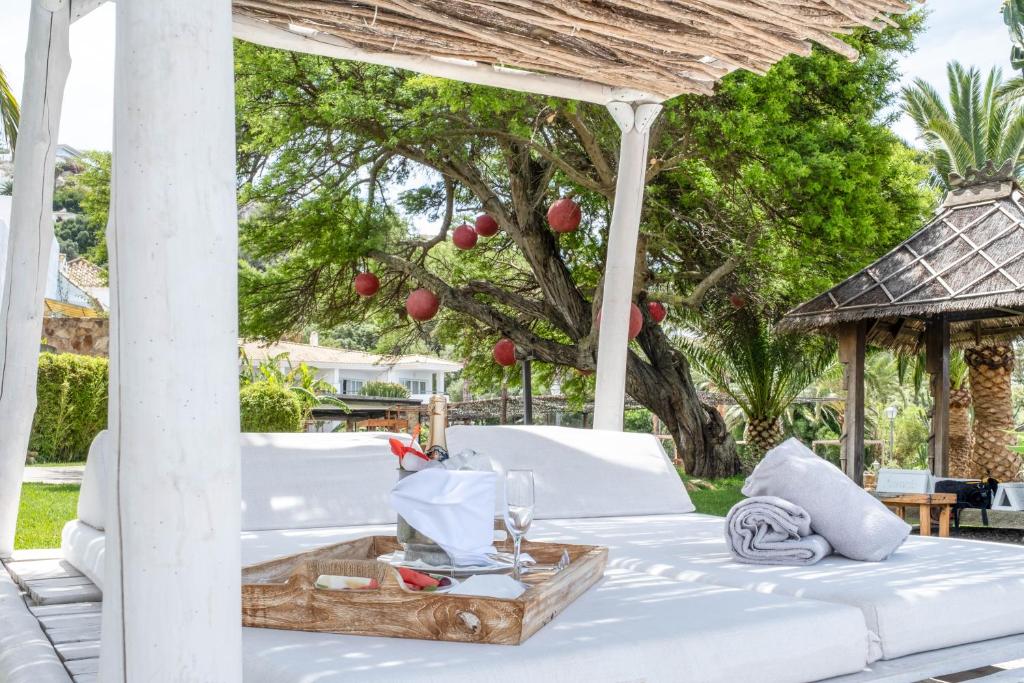 a bed under a gazebo with a table at El Cortijo de Zahara by QHotels in Zahara de los Atunes
