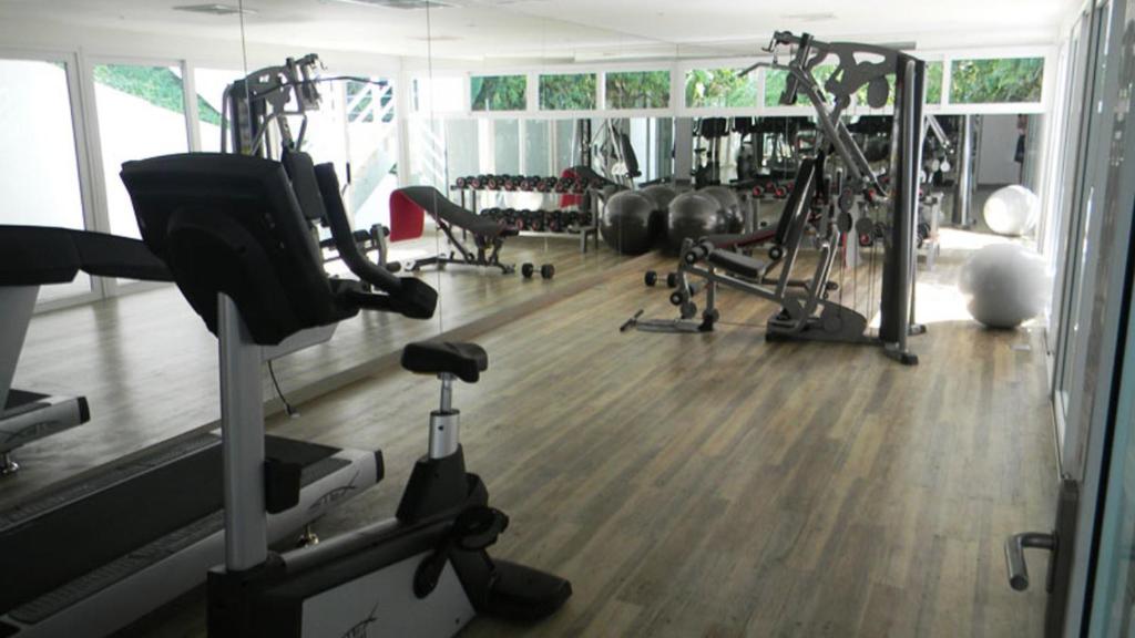 a gym with several treadmills and exercise bikes at Kata Ocean View condominium by Lofty in Kata Beach