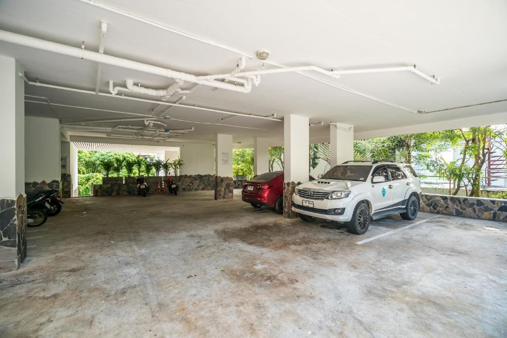 a garage with two cars parked in it at Kata Ocean View condominium by Lofty in Kata Beach