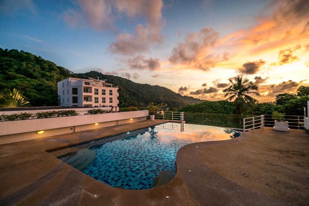 a large swimming pool in front of a building at Kata Ocean View condominium by Lofty in Kata Beach
