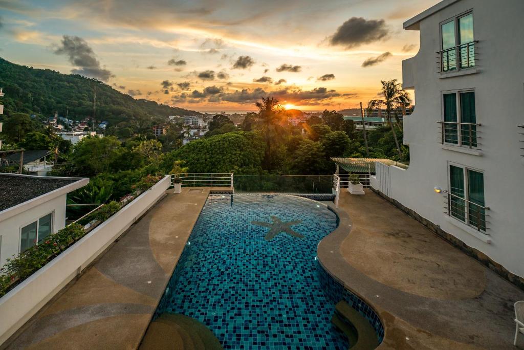 a swimming pool on the balcony of a building at Kata Ocean View condominium by Lofty in Kata Beach