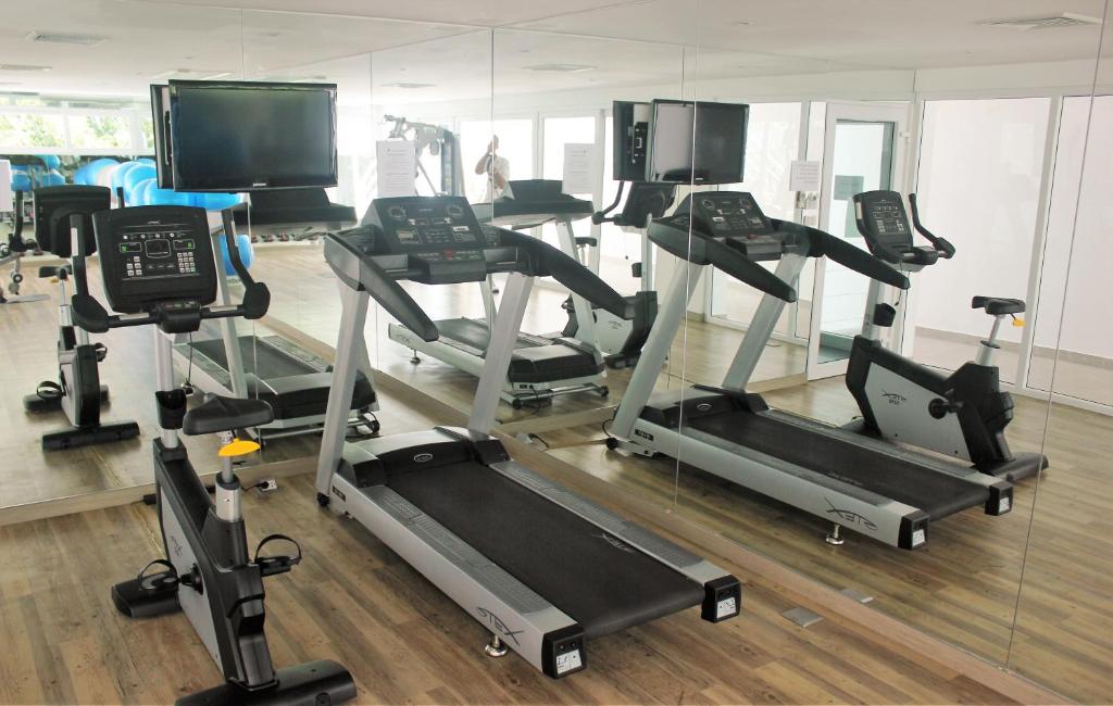 a gym with several tread machines and a mirror at Kata Ocean View condominium by Lofty in Kata Beach