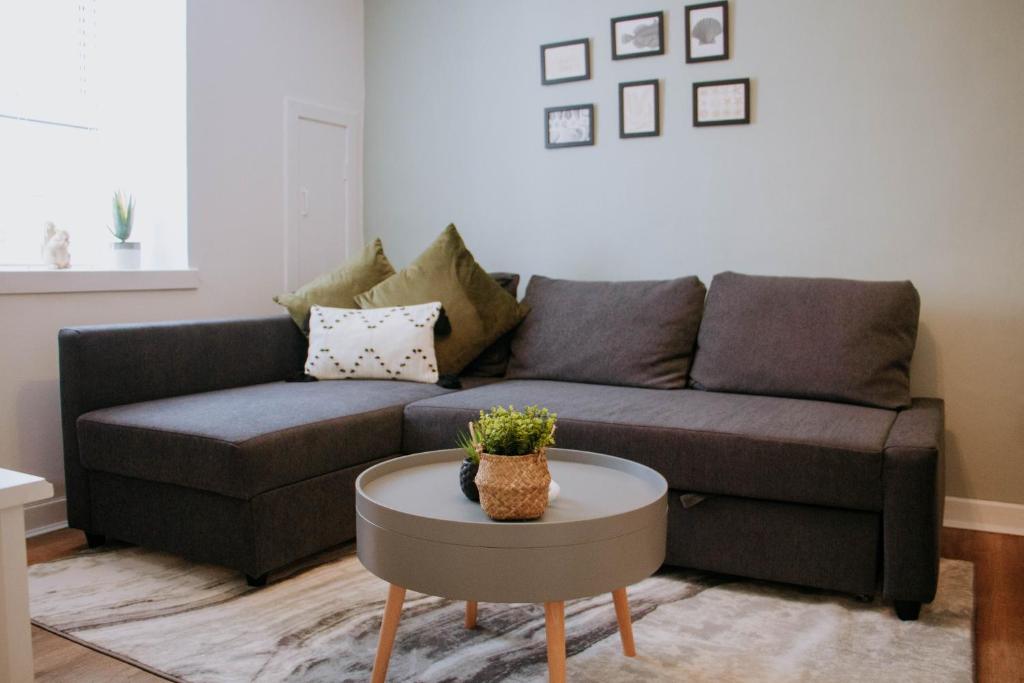 a living room with a couch and a table at The Bailey - Troon - Coorie Doon Stays in Troon