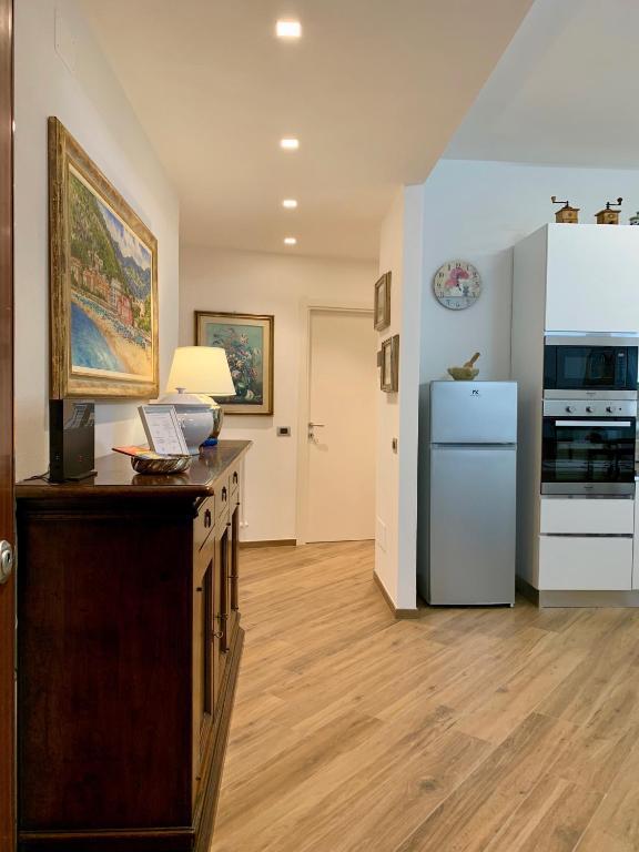a kitchen with a counter and a refrigerator in it at La Casa dei Nonni in Levanto