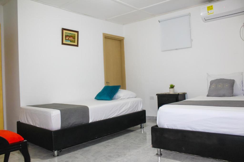 Postel nebo postele na pokoji v ubytování Hotel Poblado Suite