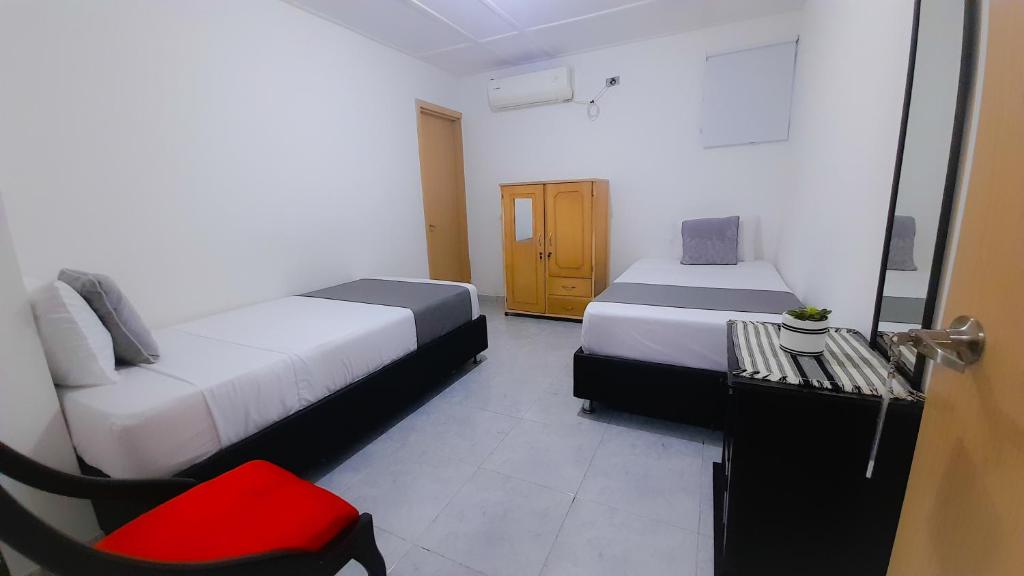 Postel nebo postele na pokoji v ubytování Hotel Poblado Suite