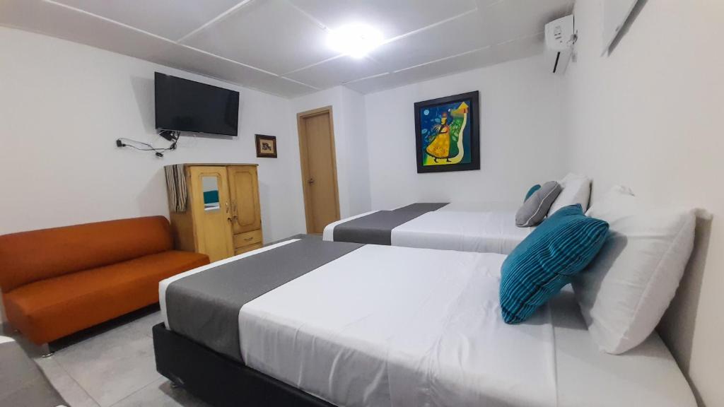 Postel nebo postele na pokoji v ubytování Hotel Poblado Suite