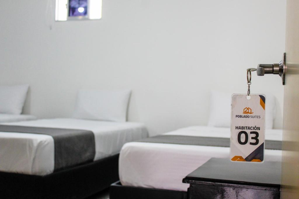 Postel nebo postele na pokoji v ubytování Hotel Poblado Suite