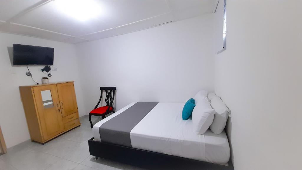 Postel nebo postele na pokoji v ubytování Hotel Poblado Suite