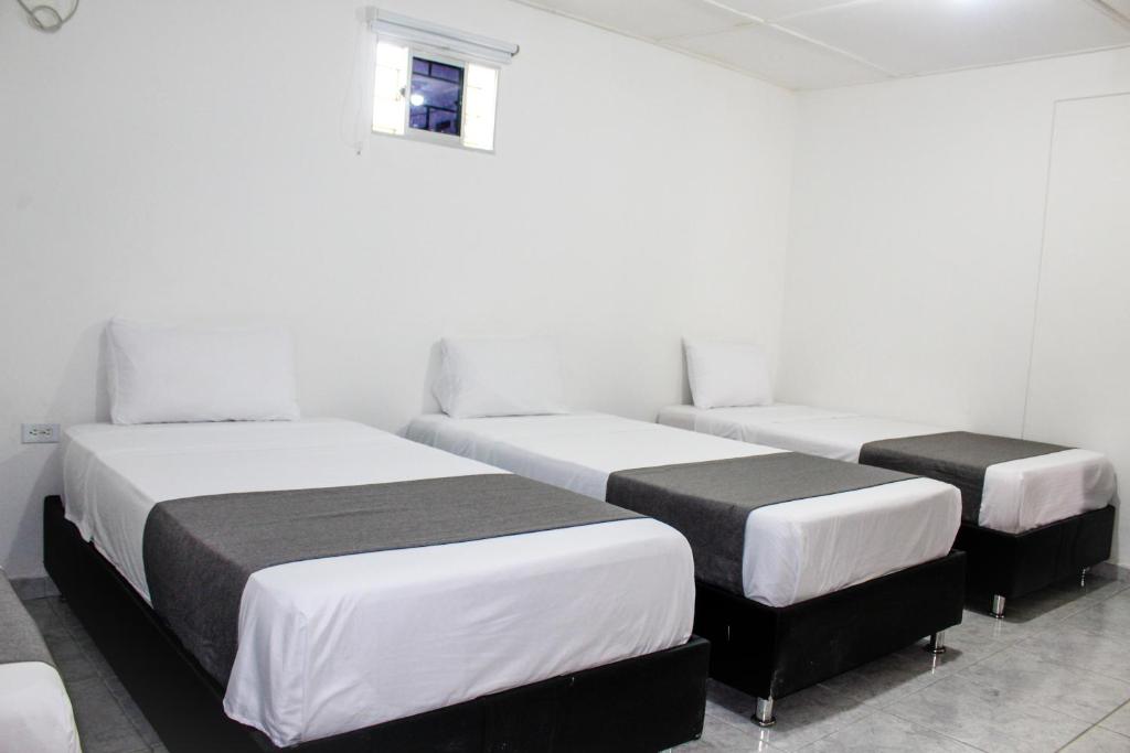 Postel nebo postele na pokoji v ubytování Hotel Poblado Suite