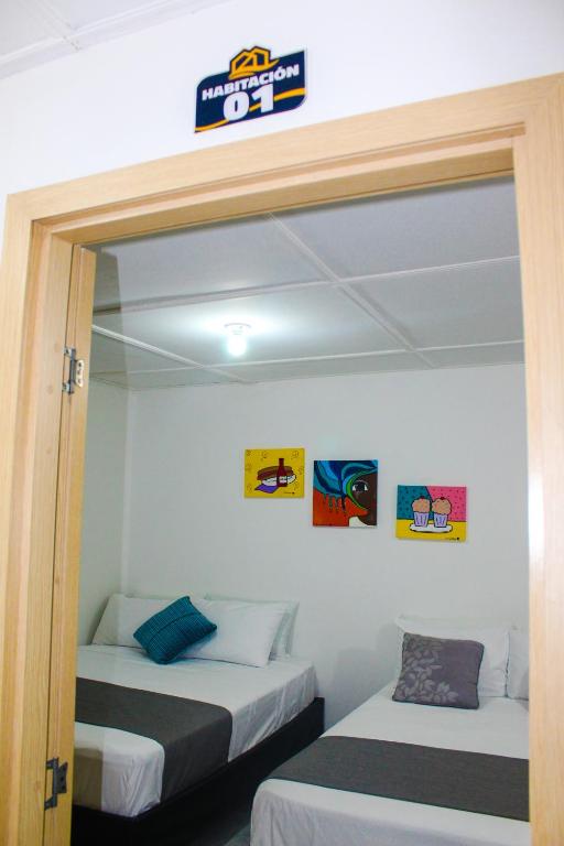 Postel nebo postele na pokoji v ubytování Hotel Poblado Suite