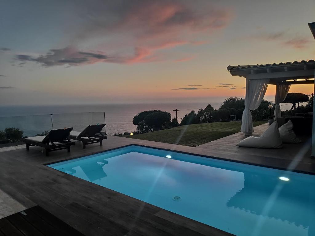 a swimming pool with a gazebo and the ocean at Villa Vardia-Amazing Seaviews with heated pool in Sinarádes