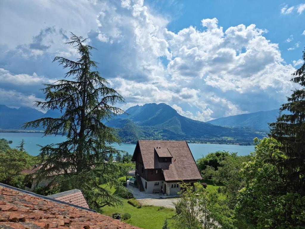 a house with a view of a lake and mountains at Petit studio vue lac / La Talloirdaze in Talloires