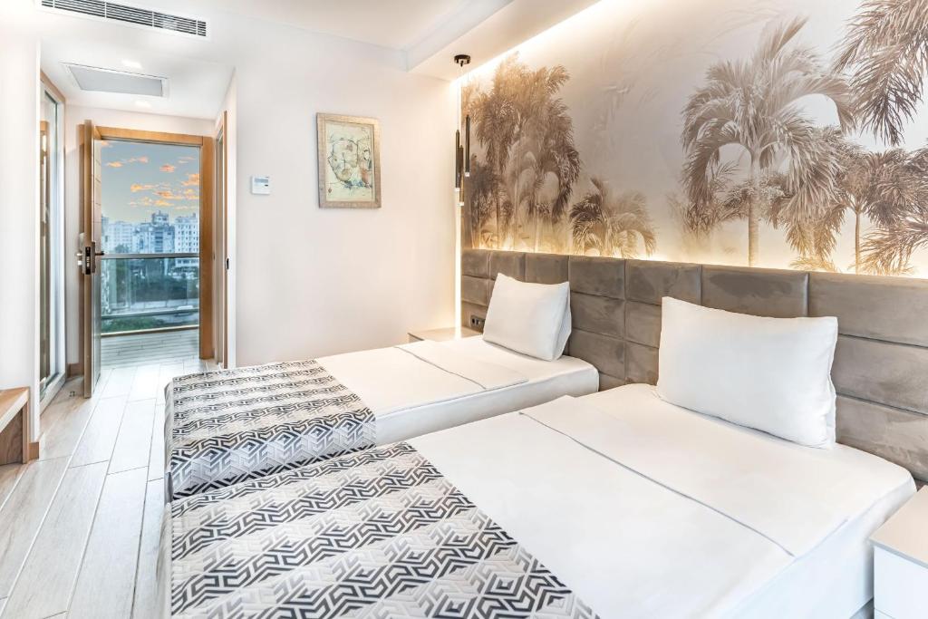 Postel nebo postele na pokoji v ubytování PEARLY HOTEL