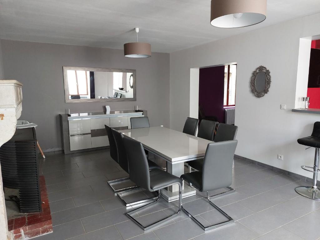 a dining room with a table and chairs at La Ribote in Sancerre