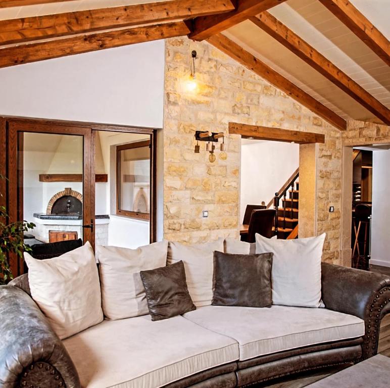 a living room with a white couch with pillows at Apartment "Istra Inspirita" in Rovinj